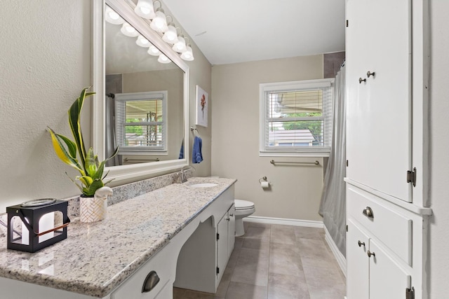 1701 W Birge St, Sherman, TX 75092 - full bathroom featuring plenty of natural light, vanity, baseboards, and toilet