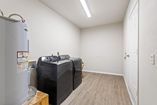 1701 W Birge St, Sherman, TX 75092 - laundry room featuring water heater, washing machine and dryer, light wood-type flooring, and baseboards