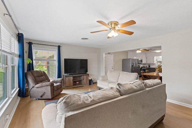 1701 W Birge St, Sherman, TX 75092 - living room featuring ceiling fan, light wood finished floors, and baseboards