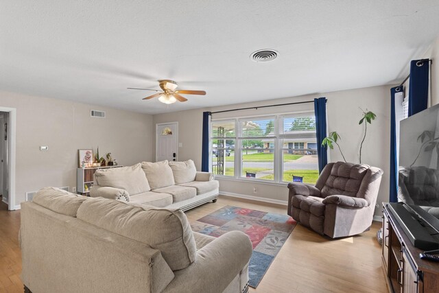 1701 W Birge St, Sherman, TX 75092 - living room with light wood-type flooring, ceiling fan, and baseboards