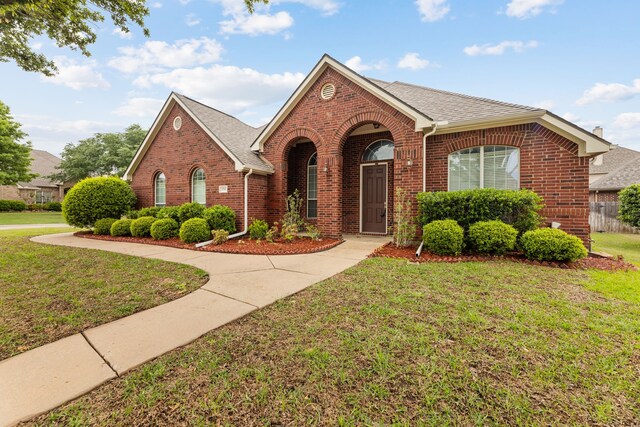 1716 Yarmouth Ln, Mansfield, TX 76063 - view of front of property featuring brick siding, a front lawn, and roof with shingles