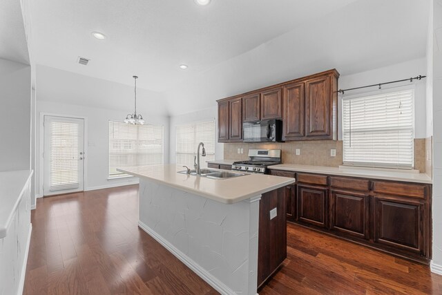 1716 Yarmouth Ln, Mansfield, TX 76063 - kitchen featuring dark wood finished floors, stainless steel gas stove, light countertops, a sink, and black microwave