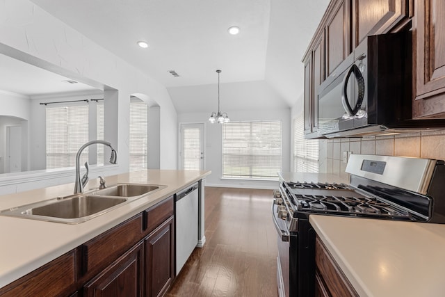 1716 Yarmouth Ln, Mansfield, TX 76063 - kitchen with arched walkways, a sink, appliances with stainless steel finishes, and light countertops