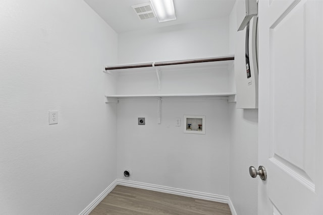 1716 Yarmouth Ln, Mansfield, TX 76063 - clothes washing area with hookup for an electric dryer, laundry area, hookup for a washing machine, baseboards, and wood finished floors