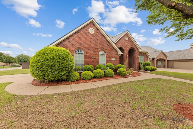 1716 Yarmouth Ln, Mansfield, TX 76063 - traditional-style home featuring a front lawn and brick siding