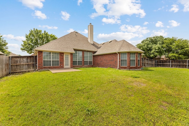 1716 Yarmouth Ln, Mansfield, TX 76063 - back of house with brick siding, a fenced backyard, and a chimney