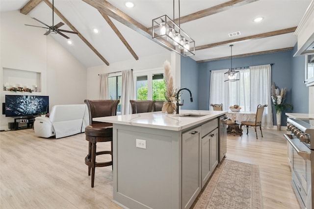 kitchen featuring a sink, gray cabinets, visible vents, appliances with stainless steel finishes, and open floor plan