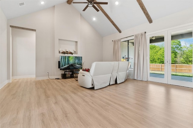 living area with beam ceiling, visible vents, ceiling fan, and light wood-type flooring