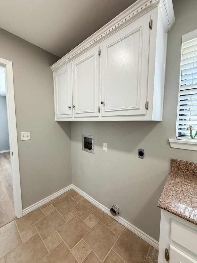 laundry room featuring hookup for an electric dryer, hookup for a washing machine, cabinet space, and baseboards