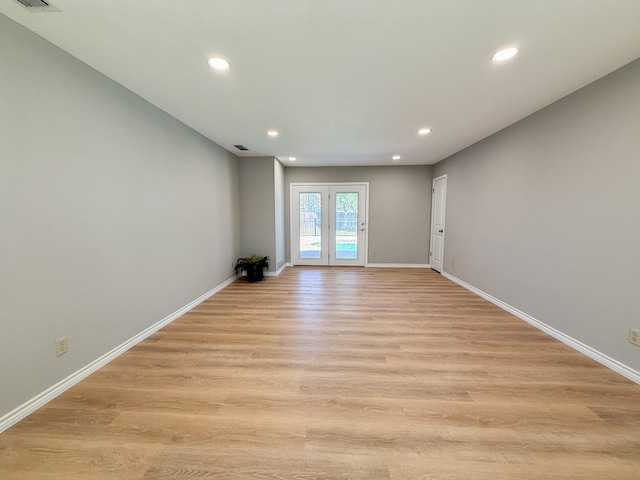 spare room with baseboards, recessed lighting, visible vents, and light wood-type flooring