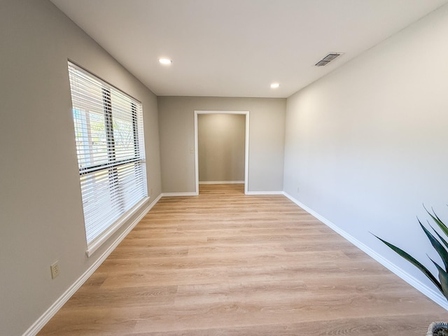 spare room with visible vents, recessed lighting, light wood-style flooring, and baseboards