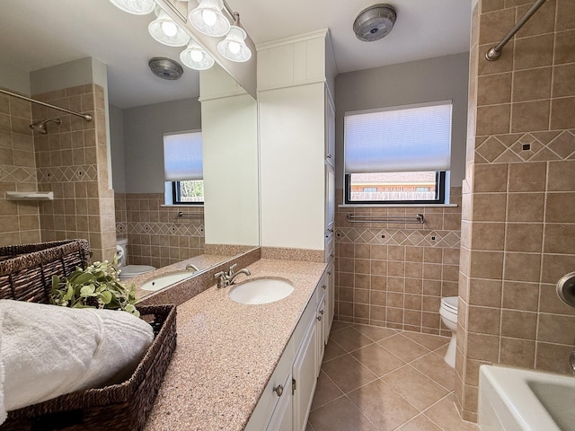full bath featuring a wainscoted wall, toilet, tile walls, vanity, and tile patterned flooring