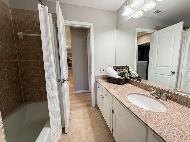 bathroom featuring shower / bathtub combination with curtain, vanity, tile patterned floors, visible vents, and baseboards