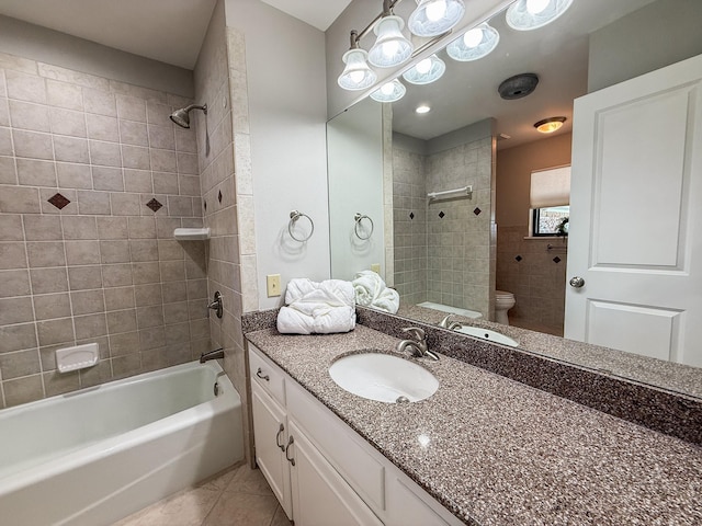 bathroom featuring tile patterned floors, bathing tub / shower combination, toilet, and vanity