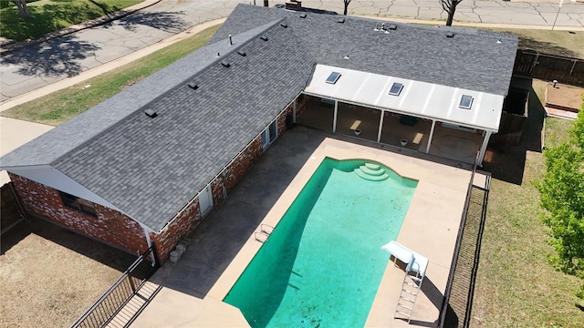 view of swimming pool featuring a diving board, a patio, a fenced in pool, and a fenced backyard