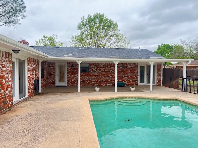 view of swimming pool featuring fence, a patio area, and a fenced in pool