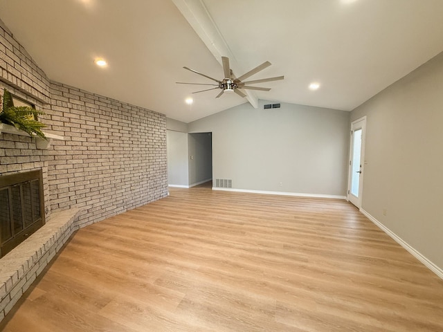 unfurnished living room featuring light wood-type flooring, visible vents, a ceiling fan, and a fireplace
