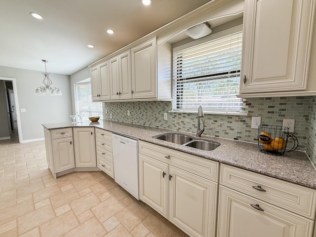 kitchen featuring recessed lighting, a sink, backsplash, and white dishwasher