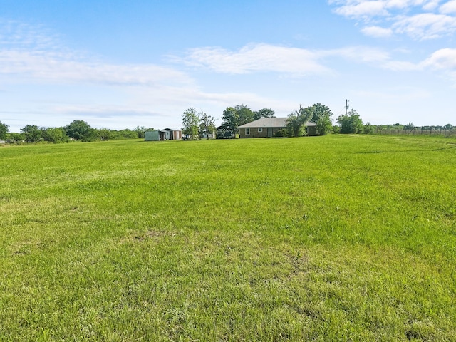 view of yard with a rural view