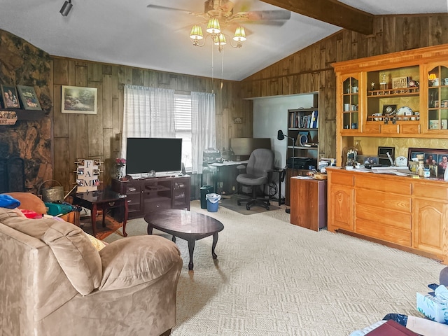 interior space featuring a ceiling fan, vaulted ceiling, and wood walls