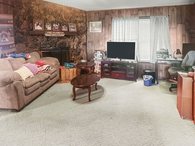 living area with carpet, wooden walls, and a fireplace