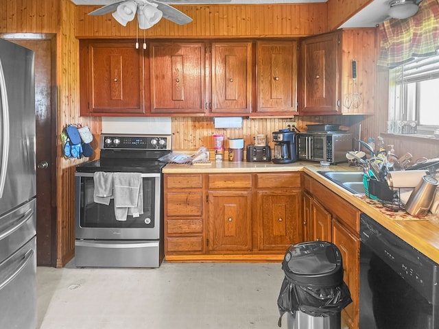 kitchen featuring light countertops, appliances with stainless steel finishes, ceiling fan, and brown cabinets