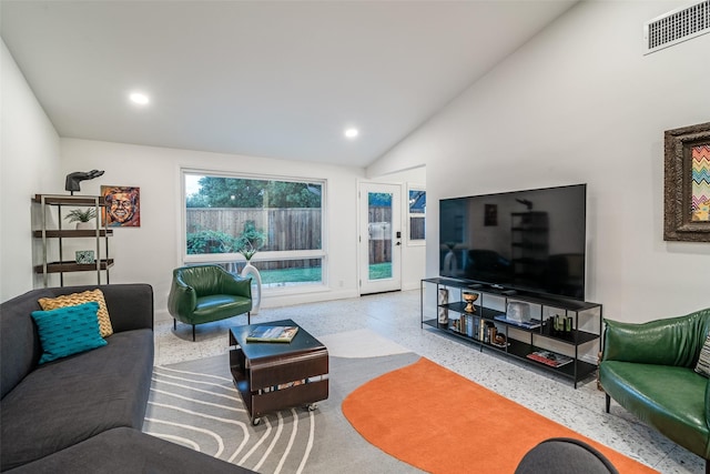 living area with recessed lighting, visible vents, speckled floor, and high vaulted ceiling