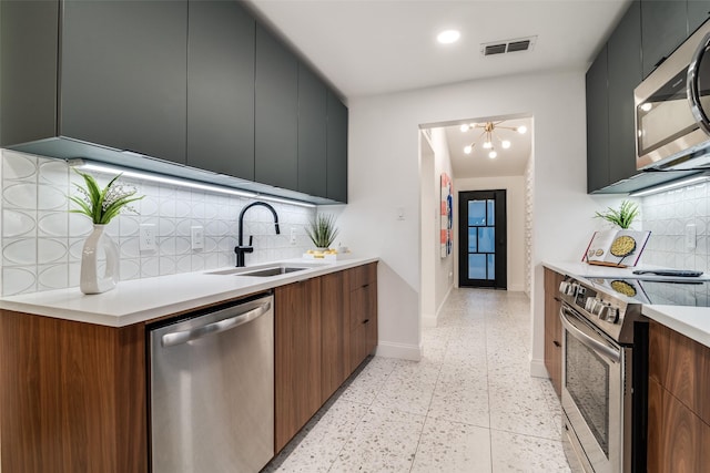 kitchen with stainless steel appliances, modern cabinets, and a sink