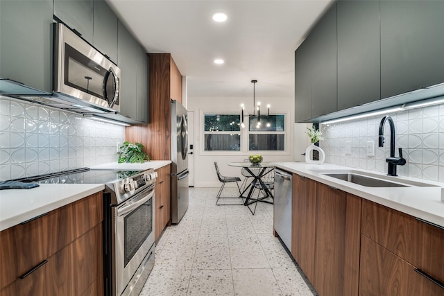 kitchen with stainless steel appliances, modern cabinets, and a sink