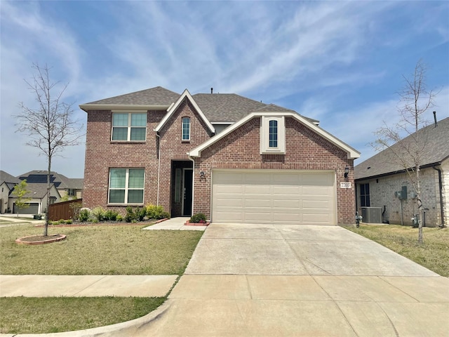 traditional-style home featuring roof with shingles, brick siding, a garage, a front yard, and driveway