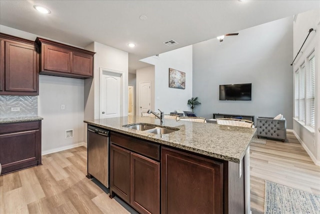 2203 Lannister St, Mansfield, TX 76063 - kitchen featuring visible vents, stainless steel dishwasher, light stone countertops, light wood-type flooring, and a sink