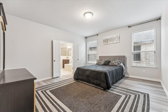 2203 Lannister St, Mansfield, TX 76063 - bedroom with baseboards, multiple windows, and light wood-style floors
