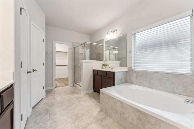 2203 Lannister St, Mansfield, TX 76063 - bathroom with a stall shower, a walk in closet, a bath, and vanity
