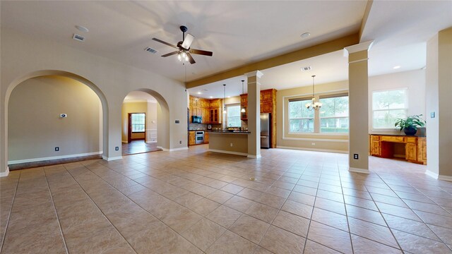 unfurnished living room featuring light tile patterned floors, visible vents, and ceiling fan
