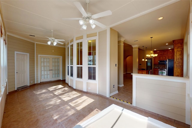 interior space featuring light tile patterned floors, french doors, ceiling fan with notable chandelier, visible vents, and vaulted ceiling