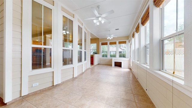 unfurnished sunroom featuring tile patterned flooring and visible vents