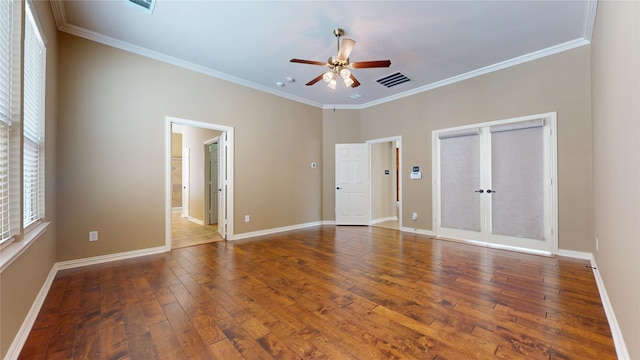 interior space featuring crown molding, visible vents, a ceiling fan, and hardwood / wood-style floors