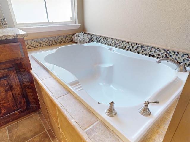 bathroom with vanity and a bath