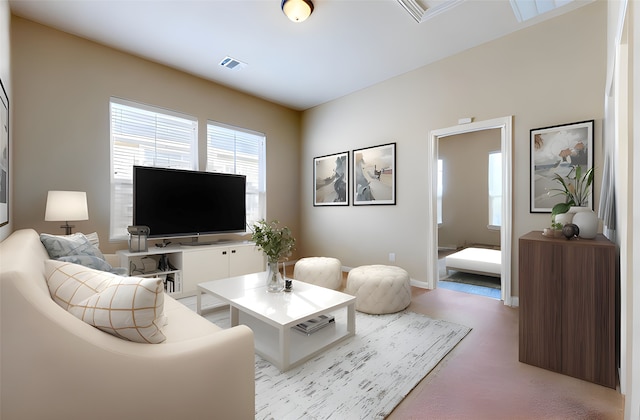living room featuring light colored carpet, a wealth of natural light, visible vents, and baseboards