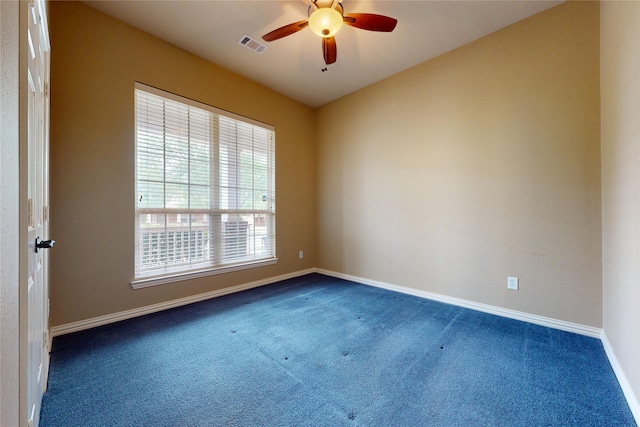 carpeted empty room featuring ceiling fan, baseboards, and visible vents