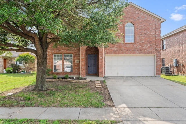 traditional-style house featuring a front lawn, central air condition unit, driveway, brick siding, and an attached garage