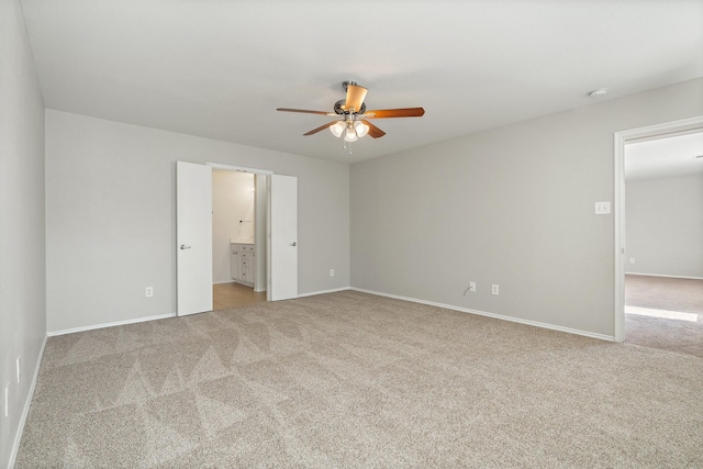 unfurnished bedroom with baseboards, ensuite bath, and carpet floors