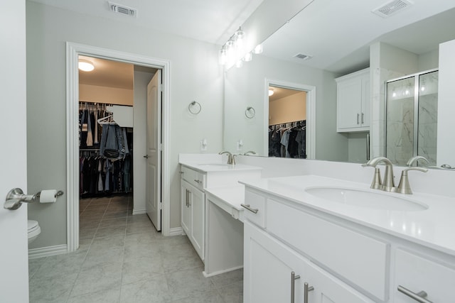 full bathroom with visible vents, a shower stall, and a sink