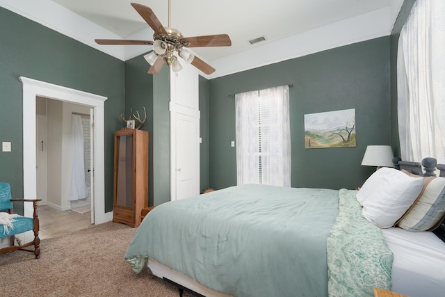 bedroom with carpet floors, visible vents, a ceiling fan, and baseboards