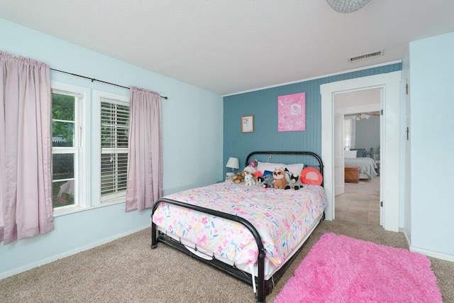 bedroom featuring carpet flooring, visible vents, and baseboards