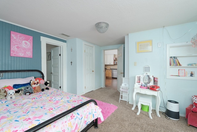carpeted bedroom featuring a textured ceiling and visible vents