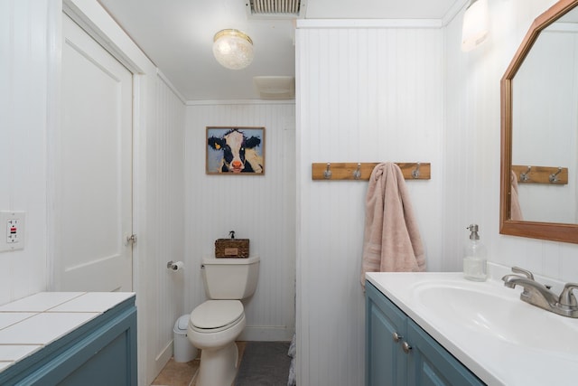 bathroom with tile patterned floors, visible vents, toilet, and vanity