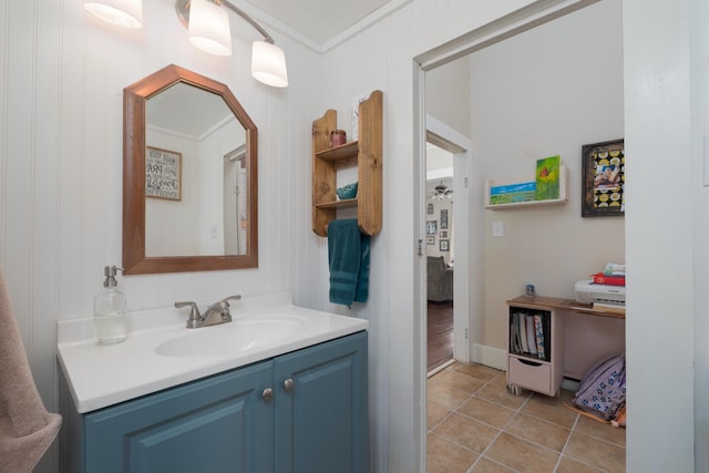 bathroom with crown molding, vanity, and tile patterned floors