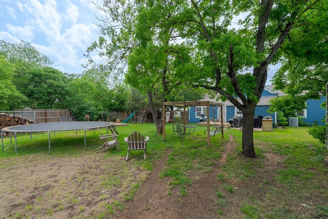 view of yard with a fenced backyard, a playground, a pergola, and a trampoline