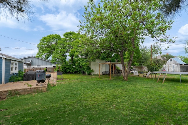 view of yard featuring a trampoline and a fenced backyard